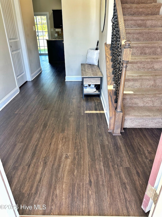 interior space featuring baseboards and wood finished floors