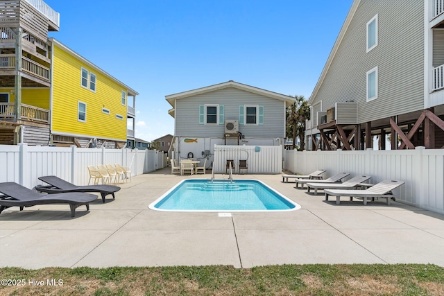 view of swimming pool with fence, a fenced in pool, and a patio area