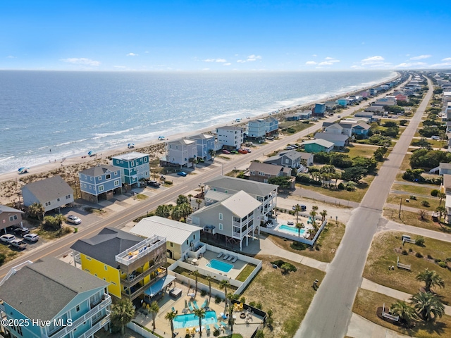 drone / aerial view with a beach view and a water view