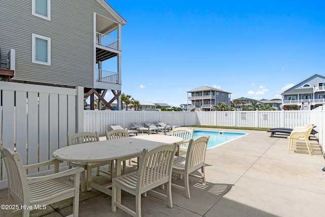 view of swimming pool with a fenced in pool, outdoor dining space, a patio area, and a fenced backyard