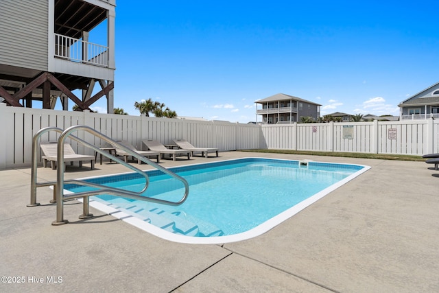 view of swimming pool featuring a patio, fence, and a fenced in pool