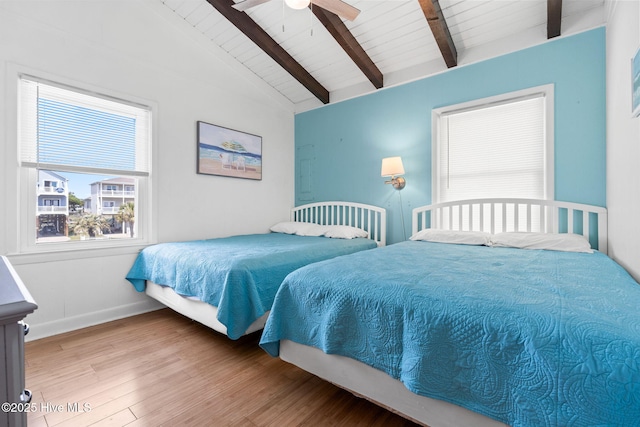bedroom featuring wooden ceiling, lofted ceiling with beams, ceiling fan, baseboards, and wood finished floors