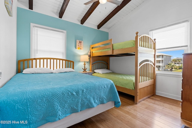 bedroom featuring wooden ceiling, wood finished floors, a ceiling fan, and vaulted ceiling with beams