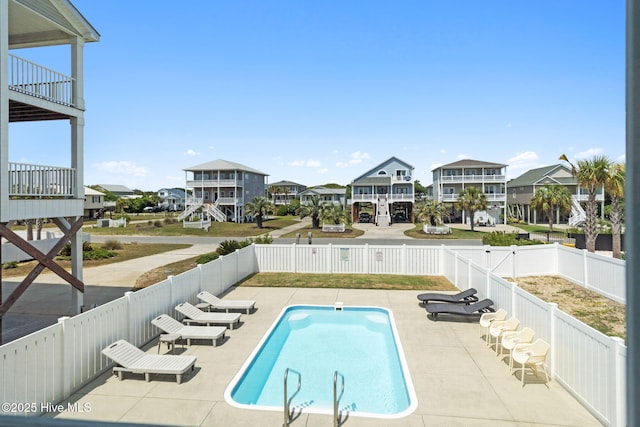 view of pool featuring a fenced backyard, a patio, a residential view, and a fenced in pool