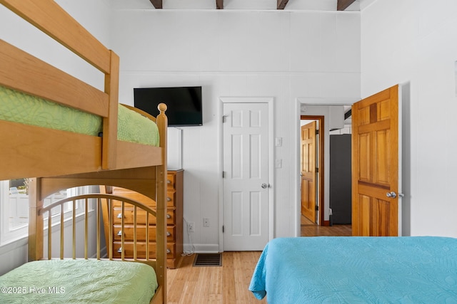bedroom featuring visible vents and wood finished floors