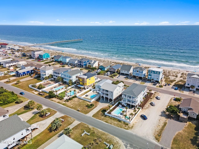 drone / aerial view featuring a view of the beach and a water view