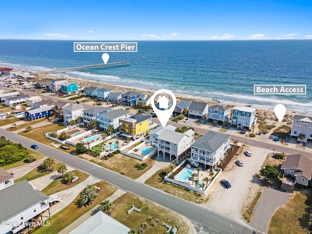 drone / aerial view featuring a water view and a view of the beach