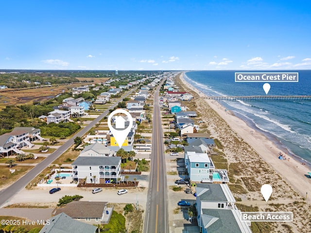 drone / aerial view with a beach view and a water view