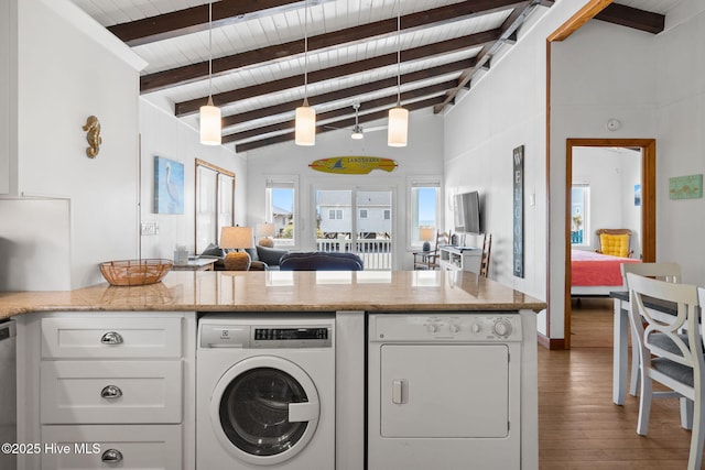 washroom with wooden ceiling, washing machine and clothes dryer, wood finished floors, and laundry area