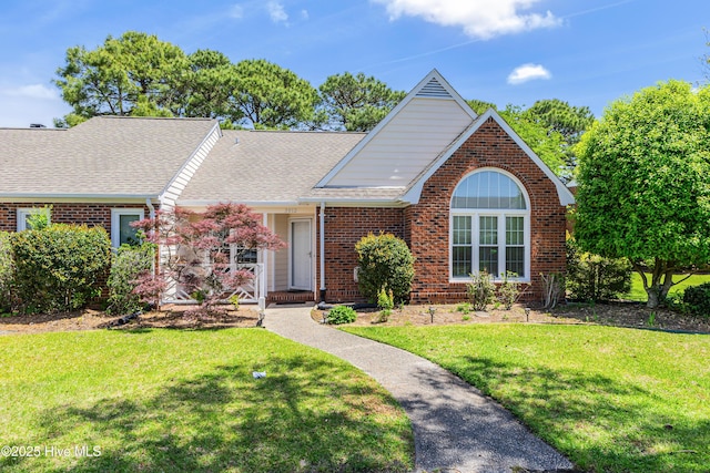 3012 Remington Dr, Wilmington, NC 28405 - ranch-style house featuring roof with shingles, a front lawn, and brick siding