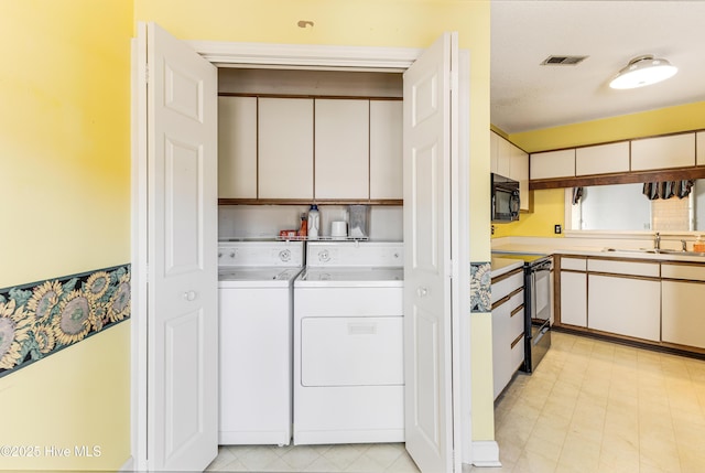 3012 Remington Dr, Wilmington, NC 28405 - laundry area with independent washer and dryer, visible vents, cabinet space, a sink, and light floors