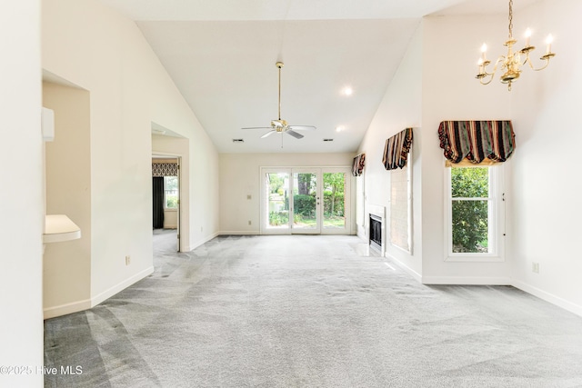 3012 Remington Dr, Wilmington, NC 28405 - unfurnished living room with a glass covered fireplace, light carpet, baseboards, high vaulted ceiling, and ceiling fan with notable chandelier