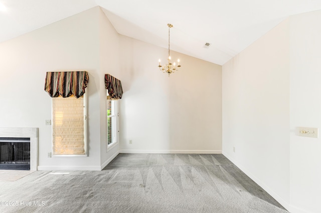3012 Remington Dr, Wilmington, NC 28405 - carpeted spare room featuring a fireplace with flush hearth, baseboards, vaulted ceiling, and a chandelier