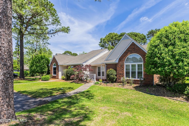 3012 Remington Dr, Wilmington, NC 28405 - single story home with brick siding, a front lawn, and roof with shingles