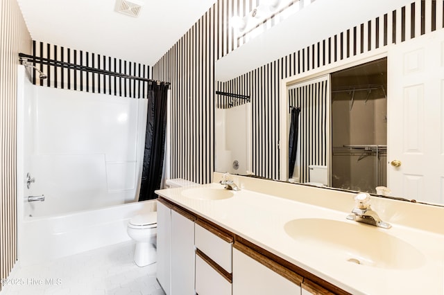 3012 Remington Dr, Wilmington, NC 28405 - bathroom with visible vents, shower / bath combination with curtain, toilet, wallpapered walls, and a sink