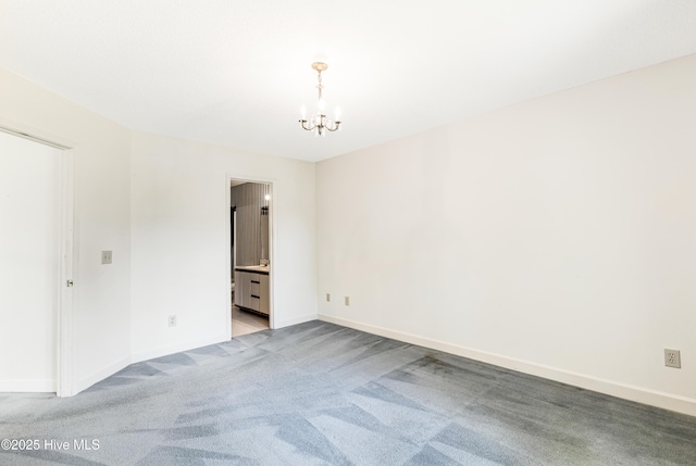 3012 Remington Dr, Wilmington, NC 28405 - unfurnished room with an inviting chandelier, baseboards, and light colored carpet