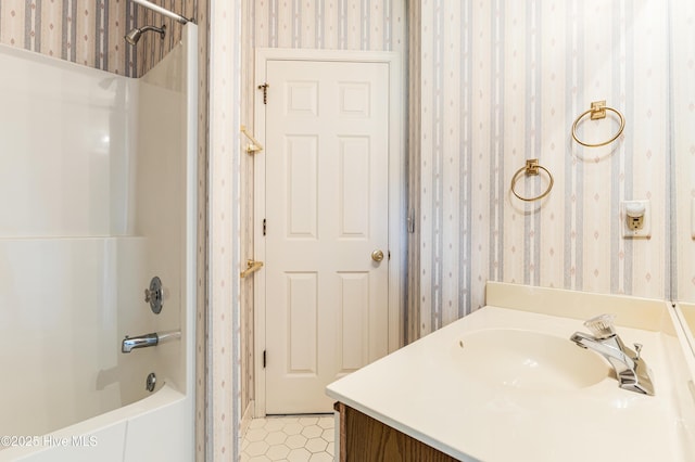3012 Remington Dr, Wilmington, NC 28405 - full bath featuring vanity, shower / tub combination, tile patterned flooring, and wallpapered walls