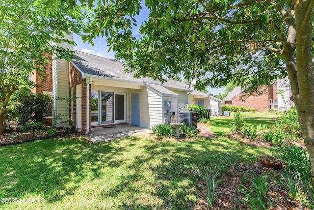 3012 Remington Dr, Wilmington, NC 28405 - back of house with a patio, roof with shingles, a chimney, central air condition unit, and a yard