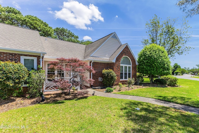 3012 Remington Dr, Wilmington, NC 28405 - view of front of house featuring brick siding, a shingled roof, and a front lawn