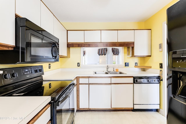 3012 Remington Dr, Wilmington, NC 28405 - kitchen with a sink, light countertops, black appliances, and white cabinetry