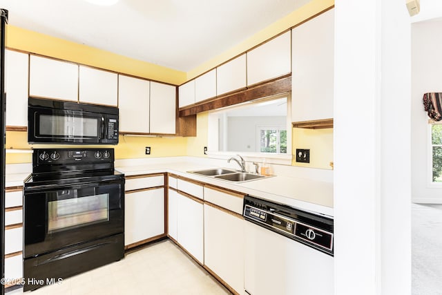 3012 Remington Dr, Wilmington, NC 28405 - kitchen featuring a sink, white cabinets, black appliances, and light countertops