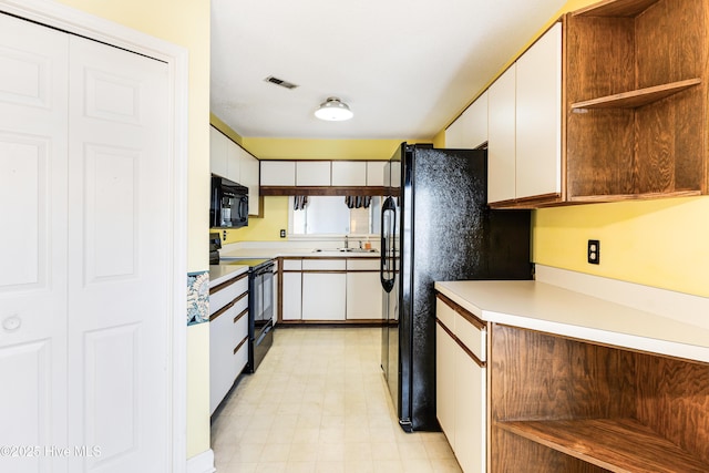 3012 Remington Dr, Wilmington, NC 28405 - kitchen with white cabinetry, open shelves, a sink, and black appliances