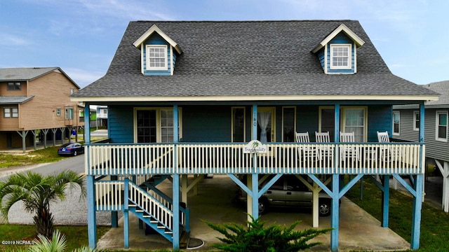 view of front of property featuring roof with shingles and covered porch