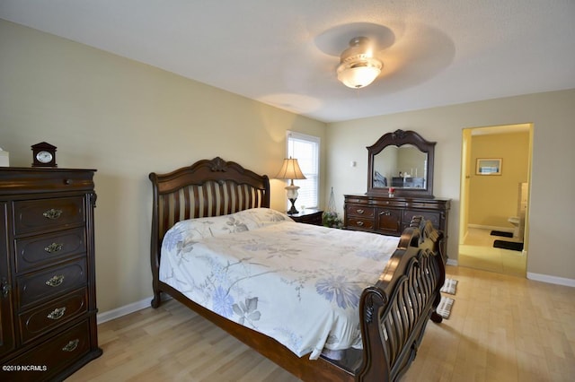 bedroom with baseboards and light wood-style flooring