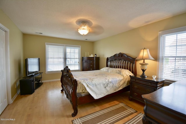 bedroom featuring baseboards, visible vents, and light wood-type flooring