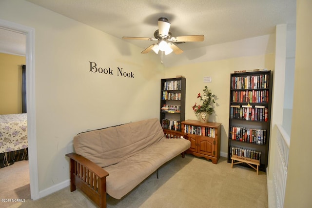 sitting room featuring carpet flooring, ceiling fan, and baseboards