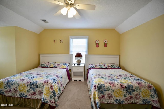 carpeted bedroom with a ceiling fan, visible vents, and vaulted ceiling