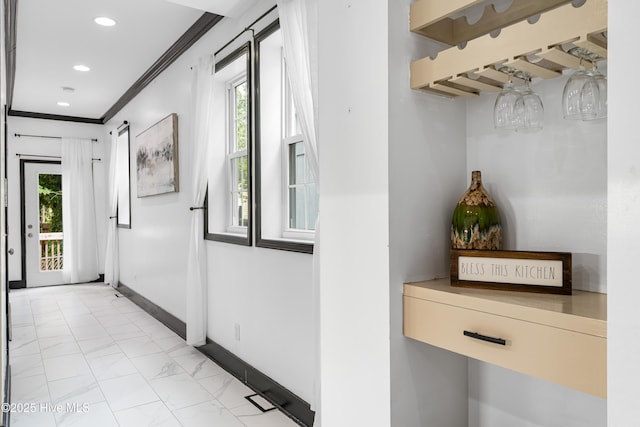 hall with baseboards, recessed lighting, ornamental molding, and marble finish floor