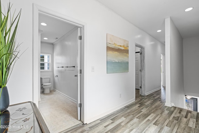 bathroom featuring baseboards, recessed lighting, wood finished floors, and toilet
