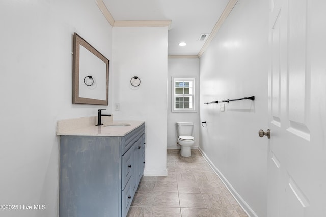 bathroom with vanity, crown molding, toilet, visible vents, and baseboards