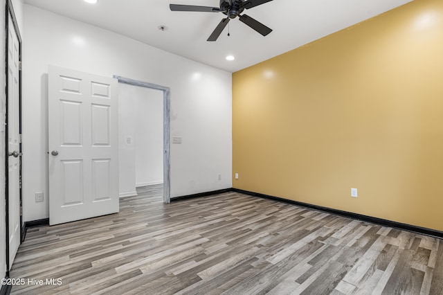 unfurnished room with recessed lighting, ceiling fan, wood finished floors, and baseboards