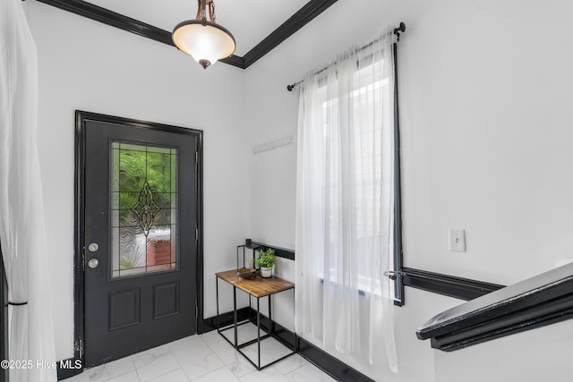 foyer entrance with ornamental molding and marble finish floor