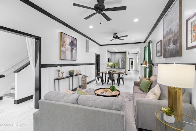 living room with ornamental molding, recessed lighting, ceiling fan, and stairway