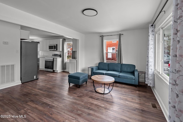 1107 Adams St N, Wilson, NC 27893 - living room with healthy amount of natural light, dark wood-type flooring, and baseboards