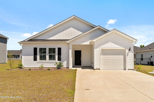 single story home with a garage, a front lawn, board and batten siding, and driveway