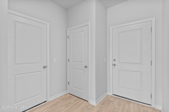 interior space featuring light wood-style floors and baseboards