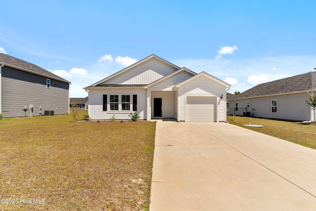 ranch-style house with a garage, a front lawn, cooling unit, board and batten siding, and concrete driveway