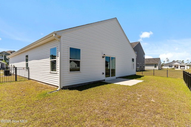 rear view of house featuring a lawn, a fenced backyard, central AC, and a patio