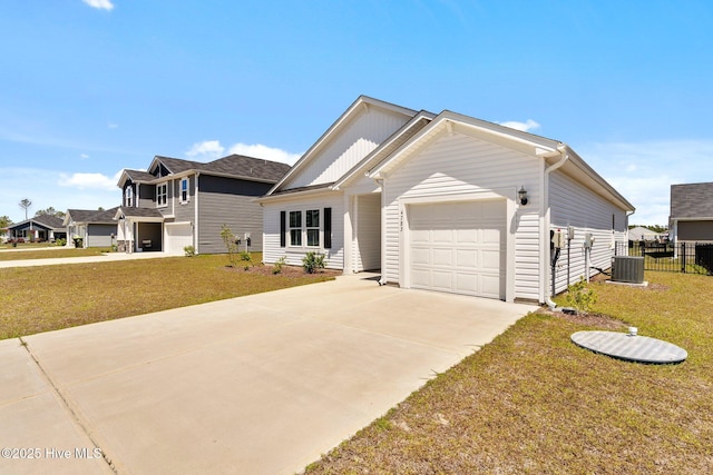 view of front of property with central air condition unit, a front yard, driveway, and a garage