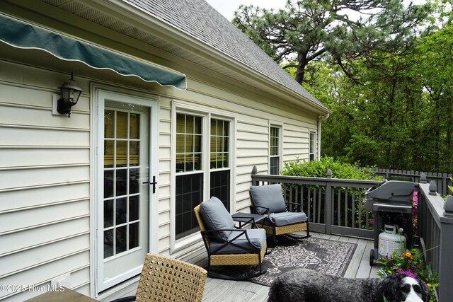 wooden deck featuring a grill