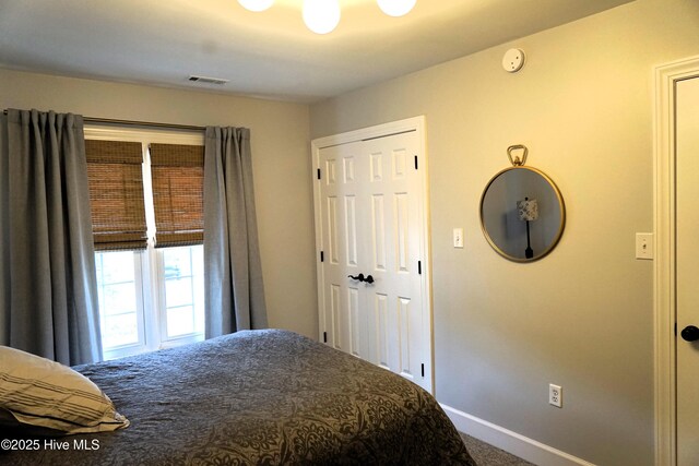 bedroom featuring baseboards, carpet, and visible vents