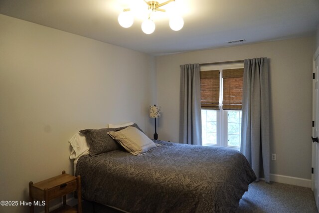bedroom featuring carpet floors, baseboards, a notable chandelier, and visible vents