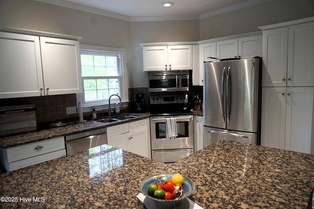 kitchen with a sink, decorative backsplash, white cabinets, and stainless steel appliances