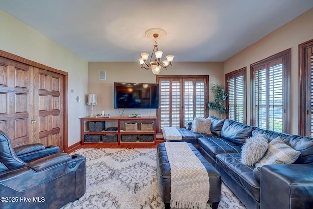 753 S Horsepen Dr, Harrells, NC 28444 - living room featuring an inviting chandelier, baseboards, wood finished floors, and visible vents