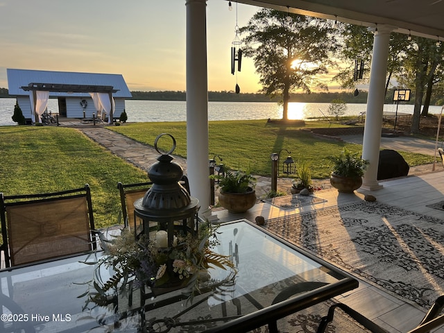 753 S Horsepen Dr, Harrells, NC 28444 - patio terrace at dusk featuring a lawn and a water view