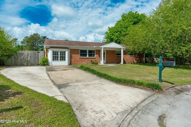 single story home featuring fence, a front lawn, concrete driveway, and brick siding